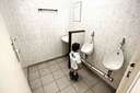 little boy at big toilet urinal