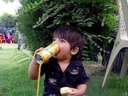 a boy drinking from a can