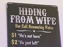 hiding from the wife sign at a bar
